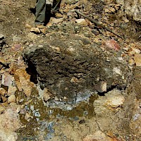 Manganocrete, a conglomerate consisting of primarily manganese and iron oxides/hydroxides leached from the surrounding metal rich rocks resulting in the cementing of alluvial materials, Copper Basin, Arizona mineral exploration site.